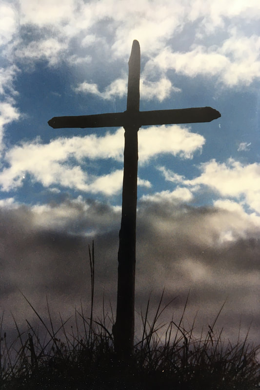 Cross outlined against sky
